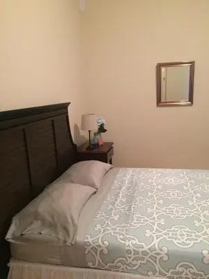 a bedroom with a bed and a mirror on the wall at Hotel Cruz Grande-Brava in Vila Nova Sintra