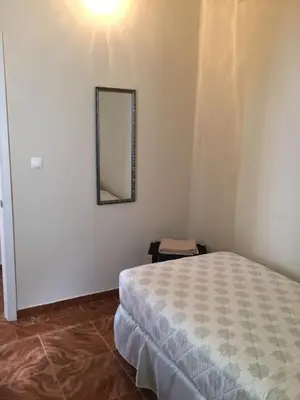a bedroom with a bed and a mirror on the wall at Hotel Cruz Grande-Brava in Vila Nova Sintra