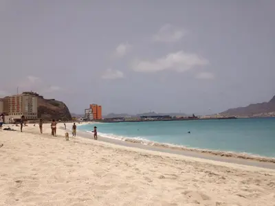 a group of people walking on the beach at Maderalzinho in Mindelo