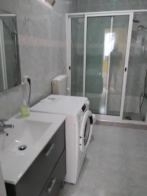 a bathroom with a sink and a washing machine at Maderalzinho in Mindelo