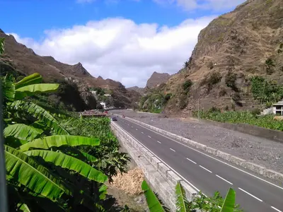 an empty road in the mountains with green plants at Damontanha in Ribeira Grande