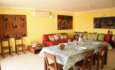 a living room with a table and a couch at Suite Mariposa Sospesa Sul Mare in Mindelo