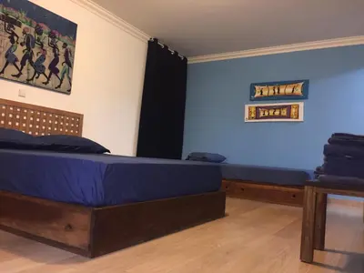 a bedroom with two beds and a painting on the wall at Suite Mariposa Sospesa Sul Mare in Mindelo