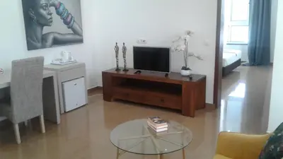 a living room with a television and a coffee table at Vista Mar in Tarrafal