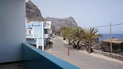 a person standing on a balcony looking at the ocean at Música do Mar in Ponta do Sol