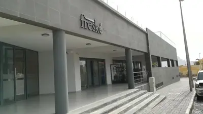 a building with a sign on the side of it at Basic Hotel in Mindelo