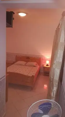 a bedroom with a bed in a room at Basic Hotel in Mindelo