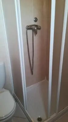 a bathroom with a shower with a toilet at Basic Hotel in Mindelo