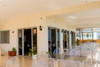 a group of tables and chairs in a room at Restaurante Residencial Nova Cidade in Porto Novo