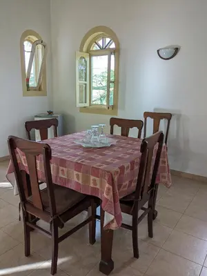 a dining room table with chairs and a table cloth at Torre Sabina in Vila do Maio