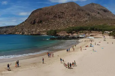 a group of people on a beach near the water at Private Holiday Apartment in Tarrafal