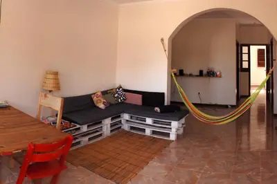 a living room with a couch and a hammock at Private Holiday Apartment in Tarrafal