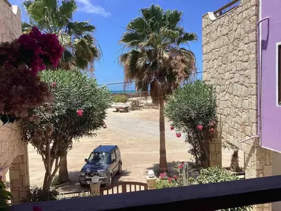 a car parked in a parking lot with palm trees at Two bedrooms, WIFI, near beach - Ca Greta in Sal Rei