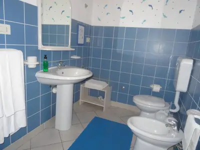 a blue tiled bathroom with a sink and a toilet at Two bedrooms, WIFI, near beach - Ca Greta in Sal Rei