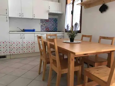 a kitchen with a wooden table and chairs at Two bedrooms, WIFI, near beach - Ca Greta in Sal Rei