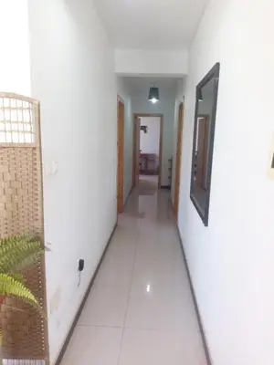 a corridor of a room with white walls and a hallway at Appart Chris Mindelo in Mindelo