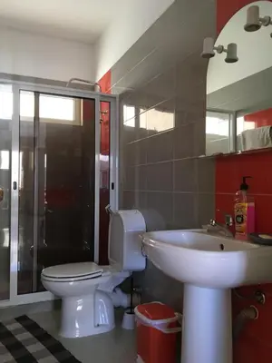a bathroom with a toilet and a sink at Appart Chris Mindelo in Mindelo