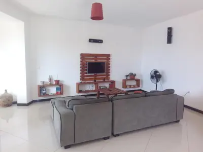 a living room with two couches and a tv at Appart Chris Mindelo in Mindelo