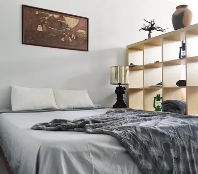 a bedroom with a bed with a gray blanket on it at My Place Apt#1 in Praia