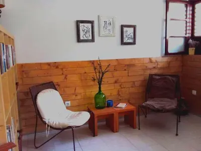 a room with two chairs and a table and a vase at My Place Apt#1 in Praia