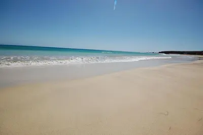 an empty beach with the ocean in the background at Villa Maris Ecolodge in Morro