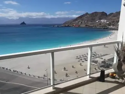 a view of a beach and the ocean from a balcony at @Georgette in Mindelo