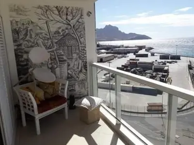 a balcony with a view of a cruise ship at @Georgette in Mindelo