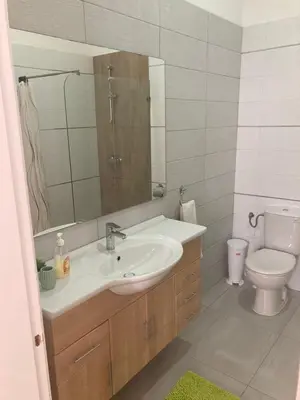 a bathroom with a sink and a toilet and a mirror at Casa Senador in Mindelo