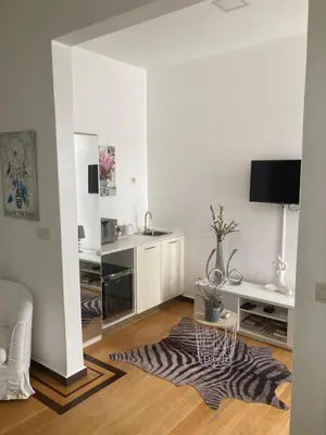 a living room with white walls and a zebra rug at Casa Senador in Mindelo