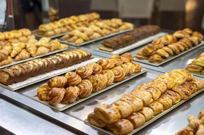a display case filled with lots of different types of pastries at Occidental Boa Vista Beach in Rabil