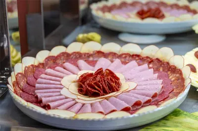 a table with several plates of food on display at Occidental Boa Vista Beach in Rabil
