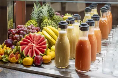 a buffet with fruits and bottles of juice at Occidental Boa Vista Beach in Rabil
