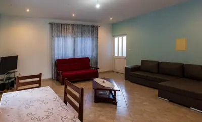 a living room with a couch and a red chair at Casa Sams in Paul