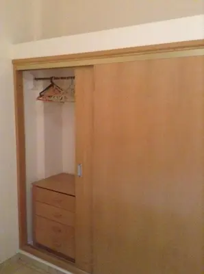 a closet with a wooden door and a dresser at Apt. Idilfa in Praia