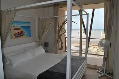 a bedroom with a bed with a view of the ocean at Ca Madeira - 2bedroom, sea view & wifi in Sal Rei
