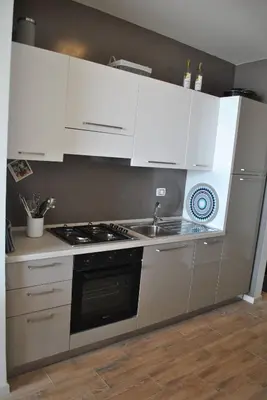a kitchen with white cabinets and a stove top oven at Ca Madeira - 2bedroom, sea view & wifi in Sal Rei