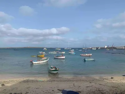 a group of boats in the water near a beach at Ca Madeira - 2bedroom, sea view & wifi in Sal Rei