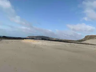 an empty beach with mountains in the background at Ca Madeira - 2bedroom, sea view & wifi in Sal Rei