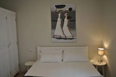a bedroom with a bed and a painting on the wall at Ca Madeira - 2bedroom, sea view & wifi in Sal Rei