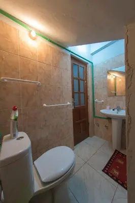 a bathroom with a toilet and a sink at Laginha Beach Guest House in Mindelo