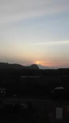 a sunset with the sun setting in the distance at Cote de France in Fundura