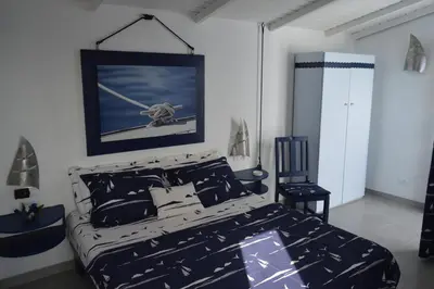 a bedroom with a bed and a picture of a plane at Yacht Club Sal in Palmeira