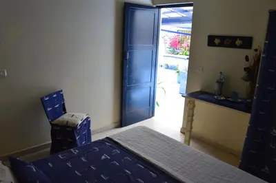 a bedroom with a bed and a door to a yard at Yacht Club Sal in Palmeira