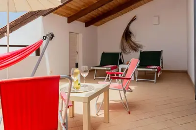 a room with chairs and a table with wine glasses at Aparthotel Ca Bonita in Sal Rei