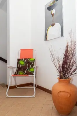 a chair and a vase in a room at Aparthotel Ca Bonita in Sal Rei