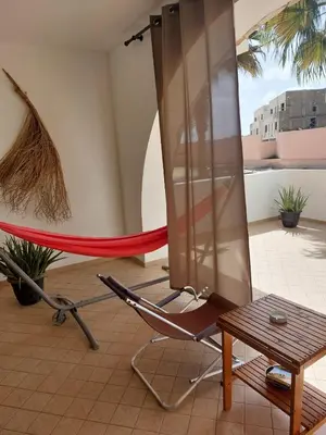 a room with a hammock and a table at Aparthotel Ca Bonita in Sal Rei