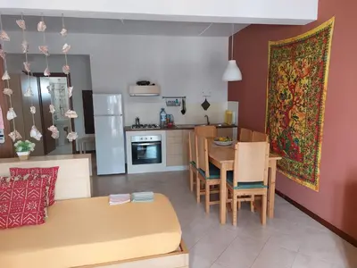 a kitchen and dining room with a table and chairs at Aparthotel Ca Bonita in Sal Rei