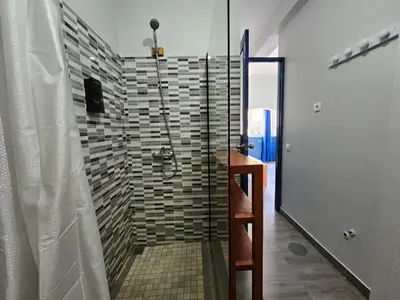 a shower with a glass door in a bathroom at kasa Tambla in Ponta do Sol