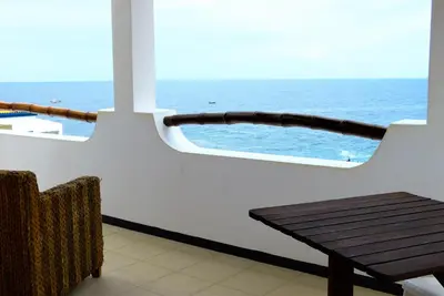 a balcony with a table and a view of the ocean at kasa Tambla in Ponta do Sol