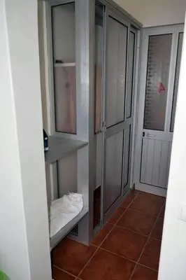 a walk in closet with glass doors in a room at Hotel Miramar Fogo Brava in São Filipe